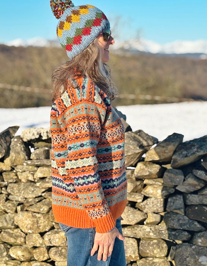 orange and teal all over Fair Isle sweater with orange ribbed hem cuffs and neckline. made from lambswool supersoft