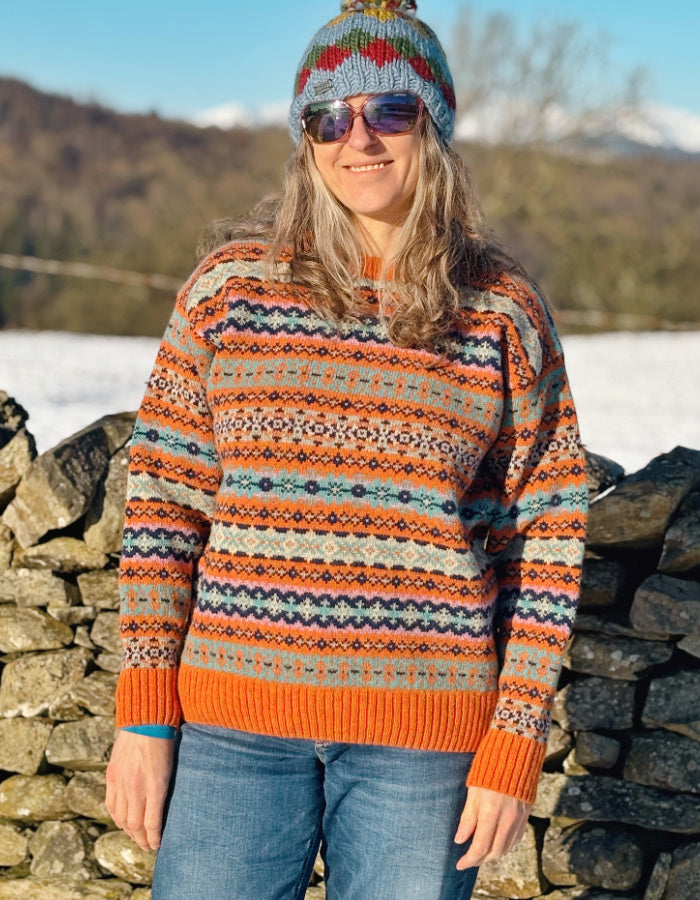 orange and teal all over Fair Isle sweater with orange ribbed hem cuffs and neckline. made from lambswool supersoft