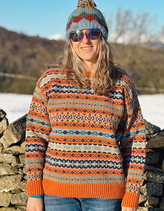 orange and teal all over Fair Isle sweater with orange ribbed hem cuffs and neckline. made from lambswool supersoft