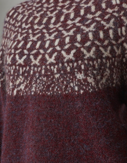 Close-up of a patterned fabric with a geometric design in red and white.