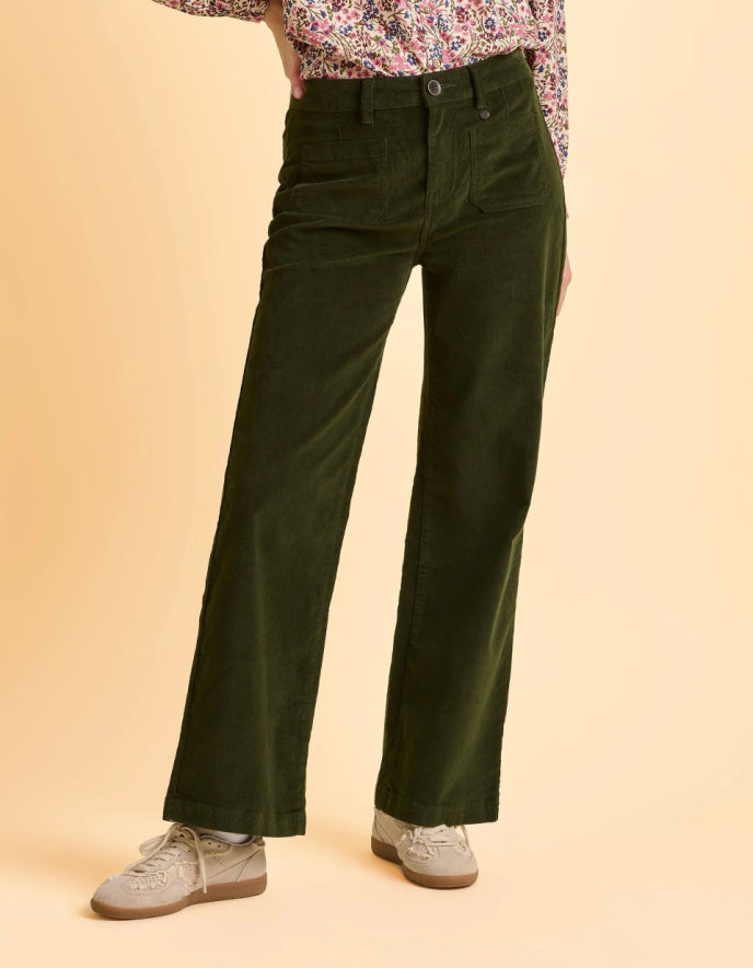 Person wearing green wide-leg pants on a beige background