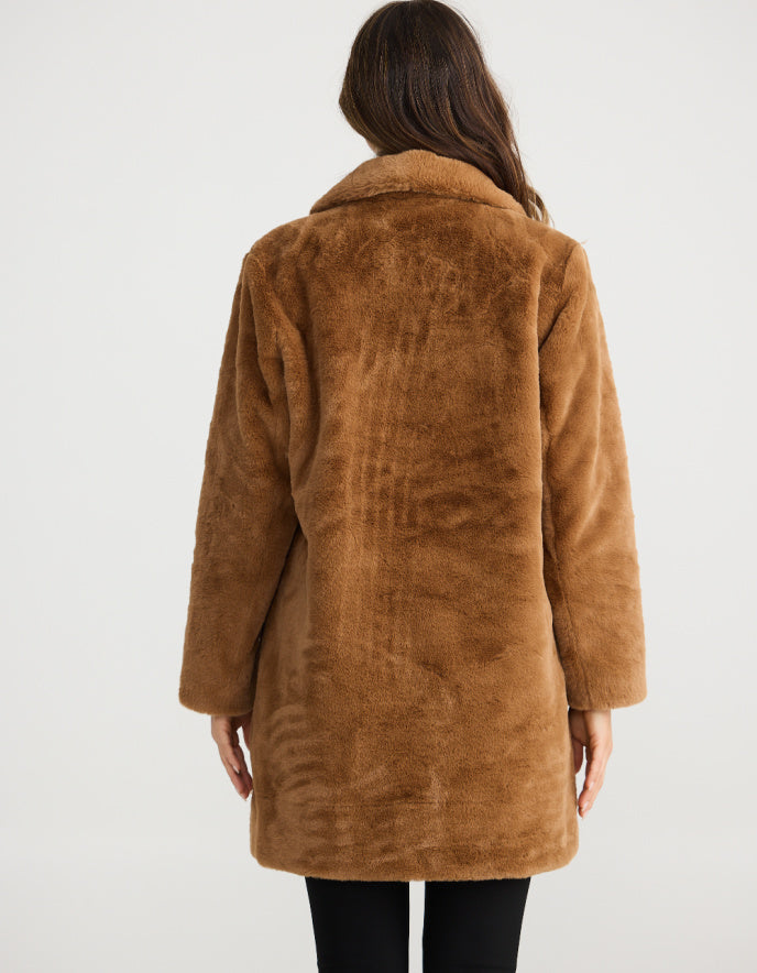 Brown coat worn by a person on a white background