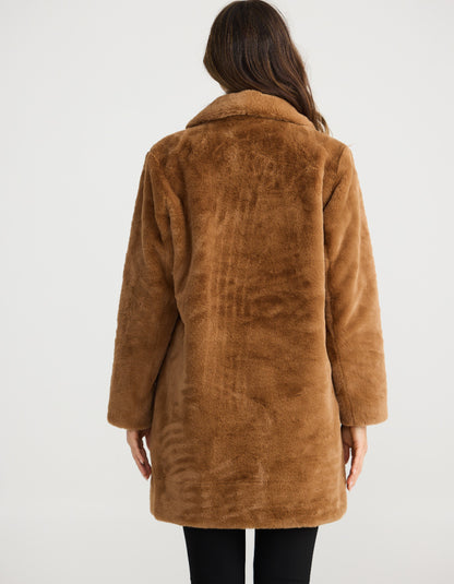 Brown coat worn by a person on a white background