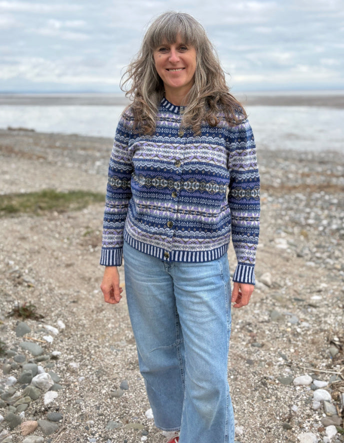 Woman wearing a blue fair isle patterned cardigan and jeans 