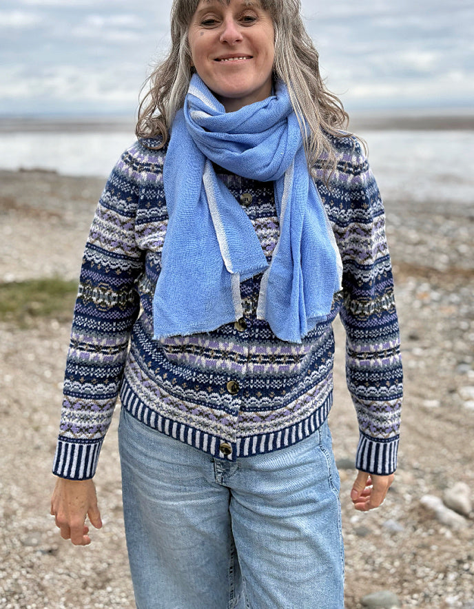 Woman wearing a blue fair isle patterned cardigan and jeans 