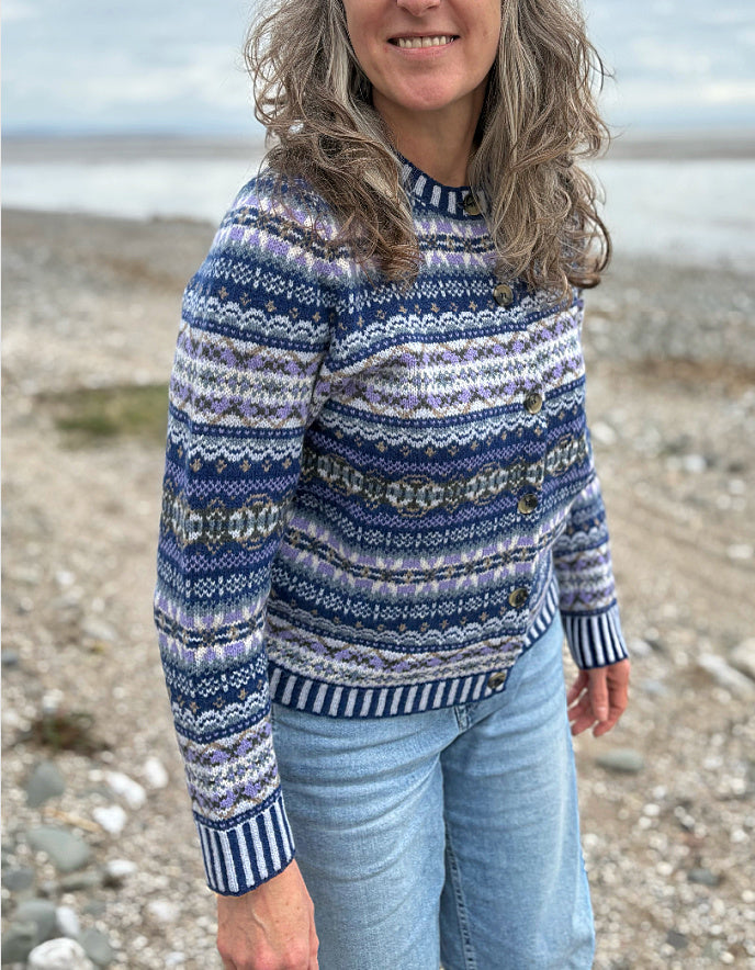 Woman wearing a blue fair isle patterned cardigan and jeans 