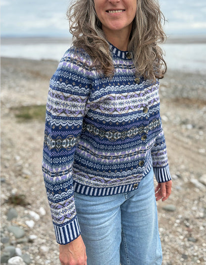 Woman wearing a blue fair isle patterned cardigan and jeans 