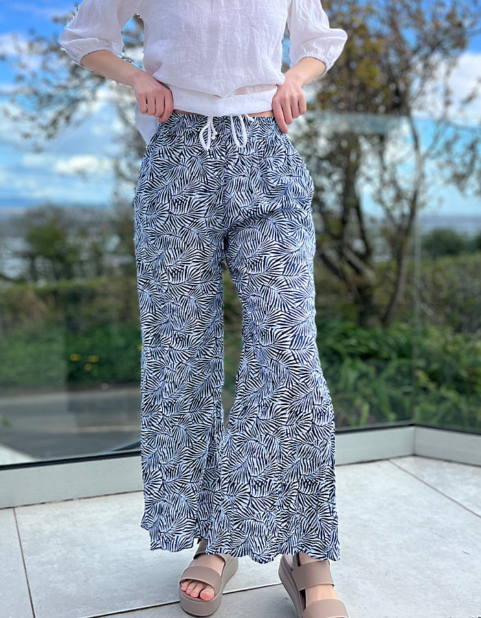 wide leg cotton crinkle trousers with elasticated waist and blue and white leaf print