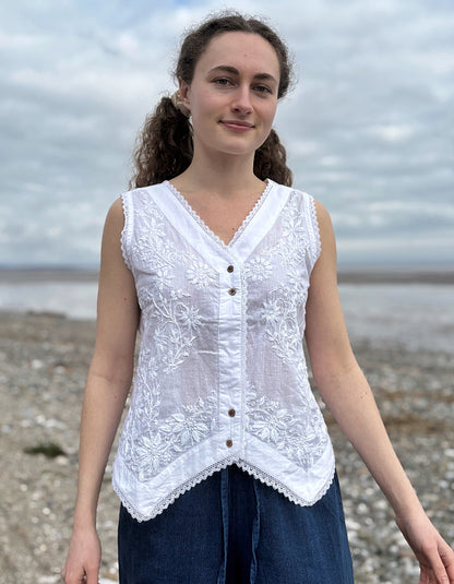 Woman wearing a white lace top on a beach