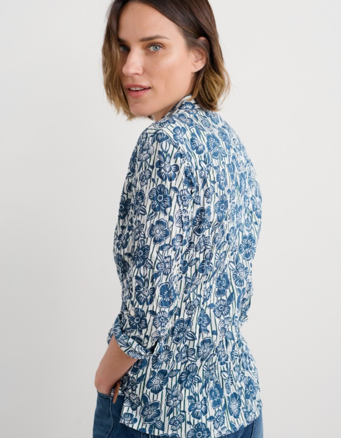 Woman wearing a blue floral blouse on a white background