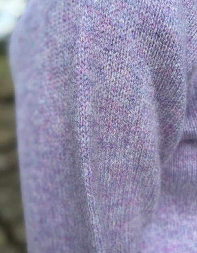 Close-up of a textured purple fabric with a blurred background
