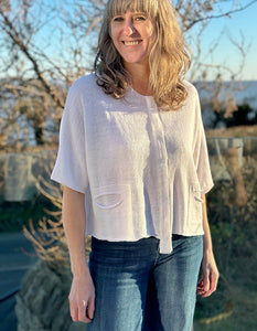 loose fit boxy white linen knitted top with elbow length sleeves and two front cut out pockets