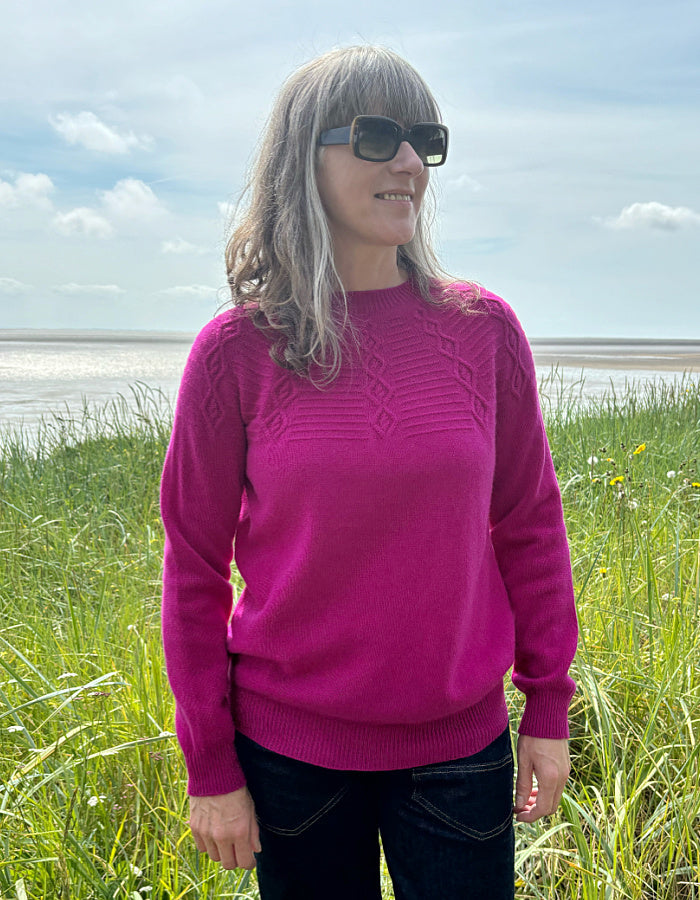 cashmere blend sweater in magenta with cable stitch design in the yoke