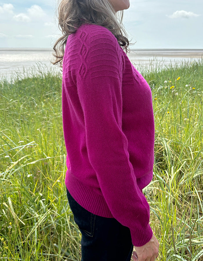 cashmere blend sweater in magenta with cable stitch design in the yoke