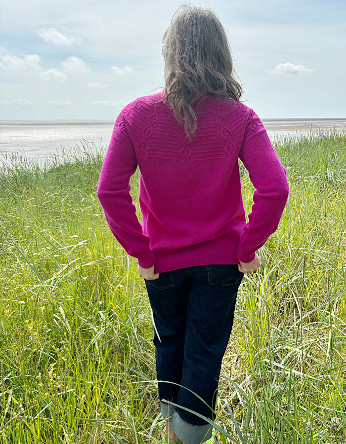 cashmere blend sweater in magenta with cable stitch design in the yoke