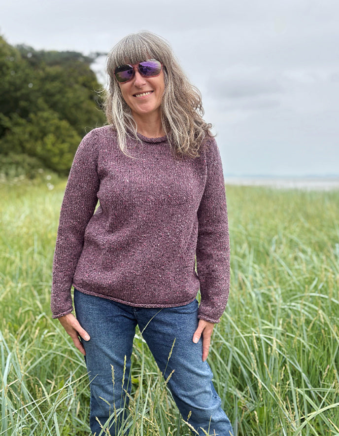 woman wearing donegal tweed dark mauve pink roll neck sweater