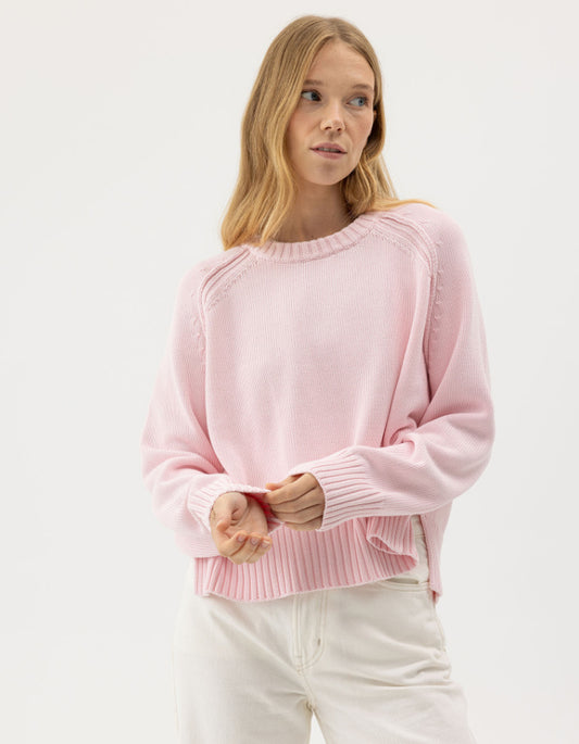 woman wearing pale [pink cotton jumper