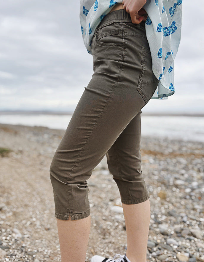 Person wearing khaki capri pants on a beach