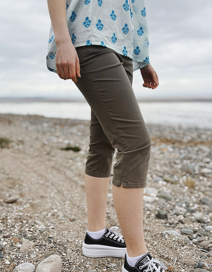 Person wearing khaki capri pants on a beach