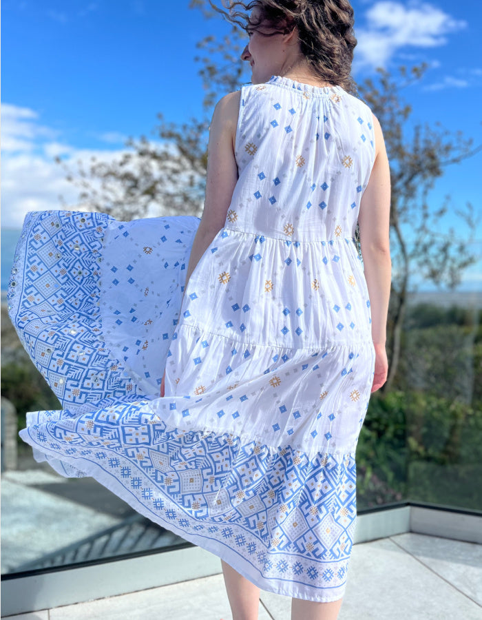white cotton sleeveless midi dress with blue and gold geo print design and small mirrored details