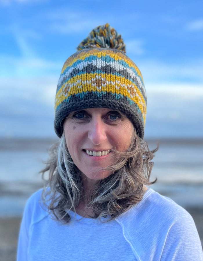 winter bobble hat in brown yellow and turquoise