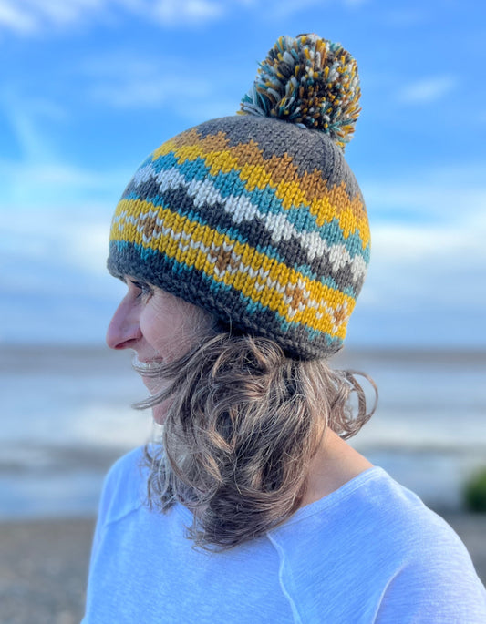 winter bobble hat in brown yellow and turquoise