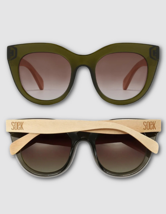 Two pairs of sunglasses shown on a light grey background: one with an olive green acetate frame and brown gradient lenses, and one with a black acetate frame and natural bamboo temple arms branded 'SOEK'.