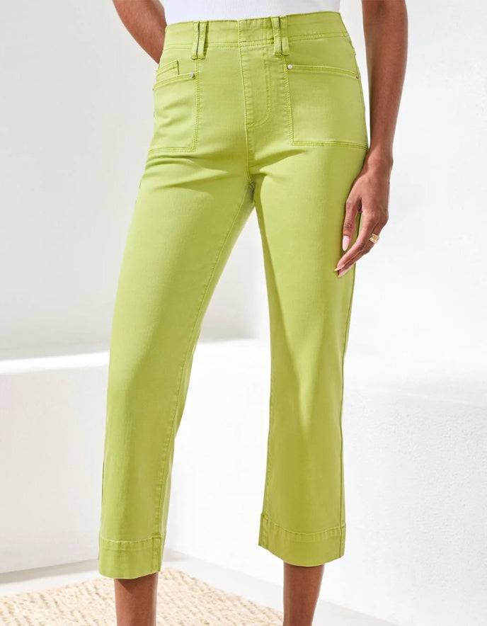 Person wearing bright green pants on a white background