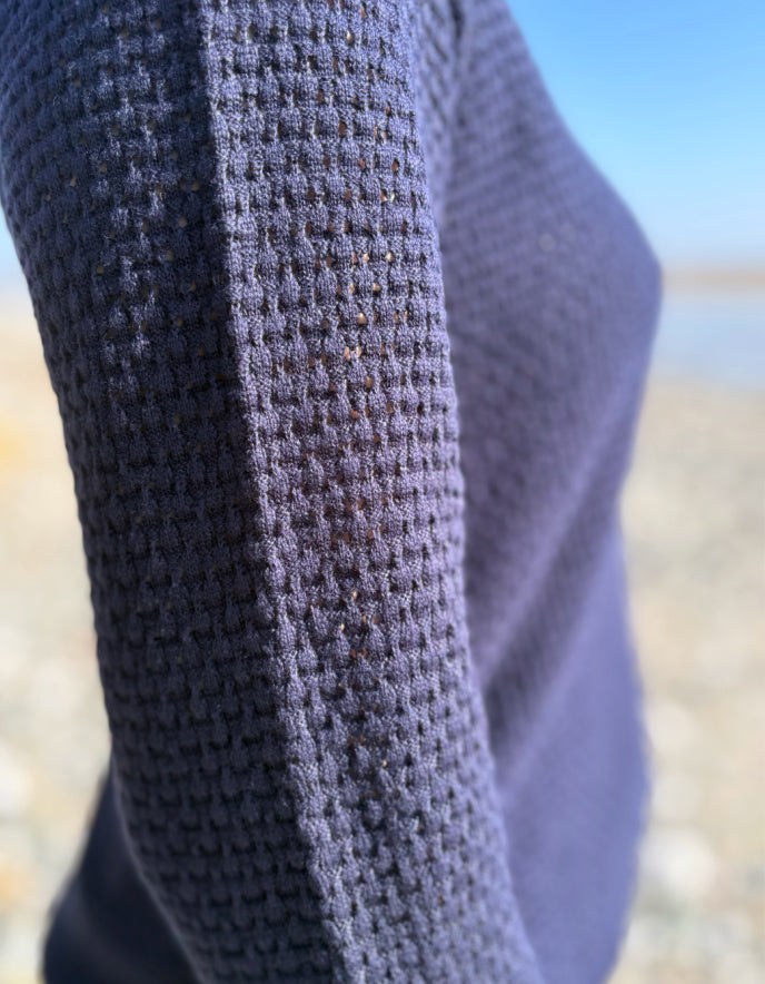 Close-up of textured fabric with a blurred natural background