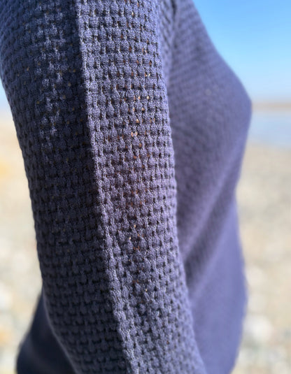 Close-up of textured fabric with a blurred natural background