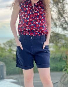 navy cotton shorts with mid thigh length front and back pockets and button and zip opening
