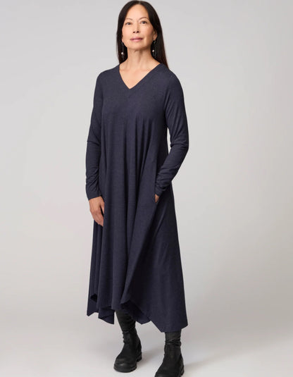Woman wearing a long navy dress on a white background