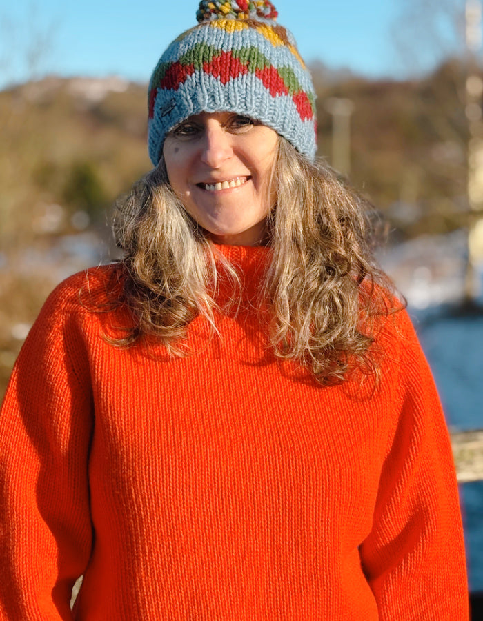 electric orange lambswool polo neck sweater with ribbed hem cuffs and neckline