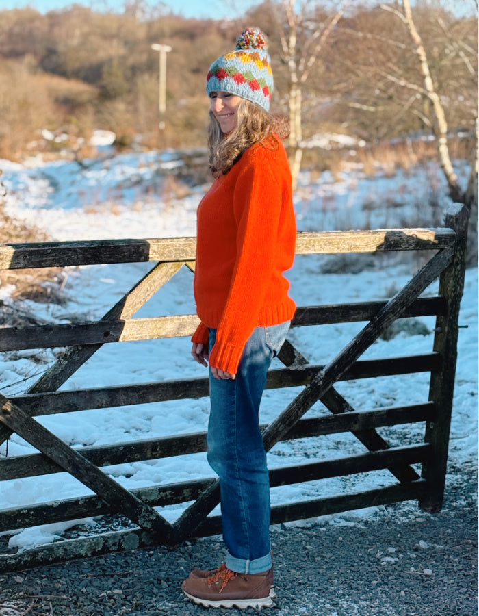 electric orange lambswool polo neck sweater with ribbed hem cuffs and neckline