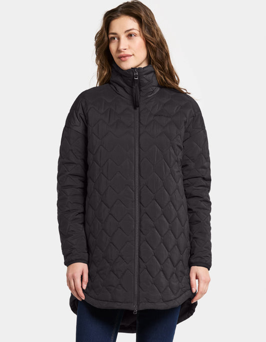 Woman wearing a black quilted jacket on a white background