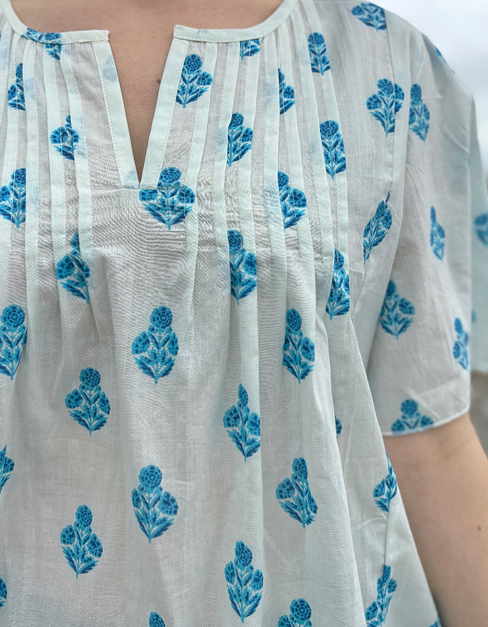 White garment with blue floral patterns