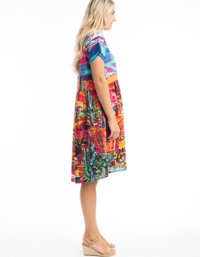 knee length loose fit cotton sun dress with capped sleeves and empire line was it in bright coloured Mexican themed print