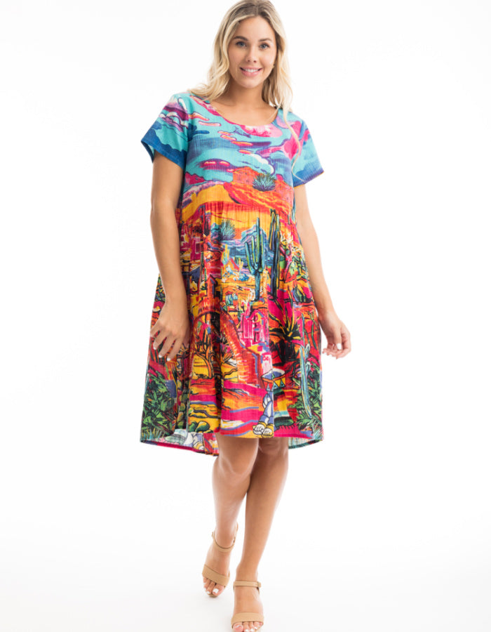 knee length loose fit cotton sun dress with capped sleeves and empire line was it in bright coloured Mexican themed print