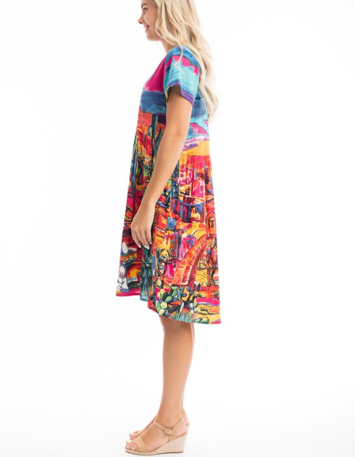 knee length loose fit cotton sun dress with capped sleeves and empire line was it in bright coloured Mexican themed print