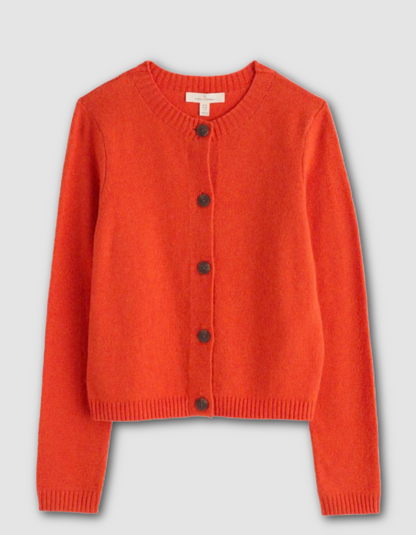 Orange cardigan with buttons on a light gray background