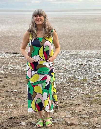 midi length linen dress with square neckline, sleeveless with pockets in abstract print in green pink yellow and navy