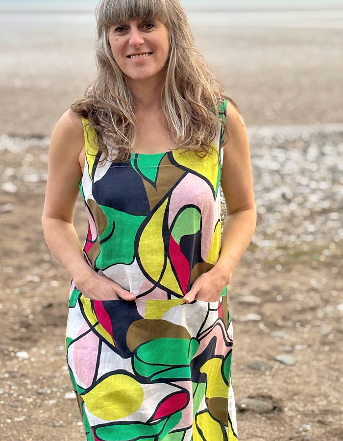 midi length linen dress with square neckline, sleeveless with pockets in abstract print in green pink yellow and navy