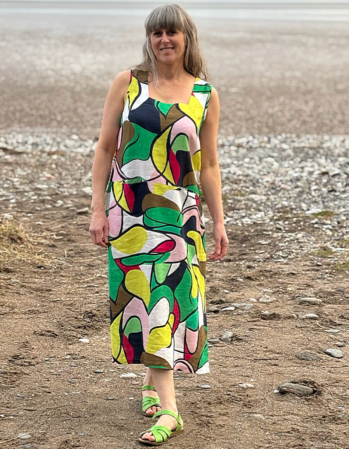 midi length linen dress with square neckline, sleeveless with pockets in abstract print in green pink yellow and navy