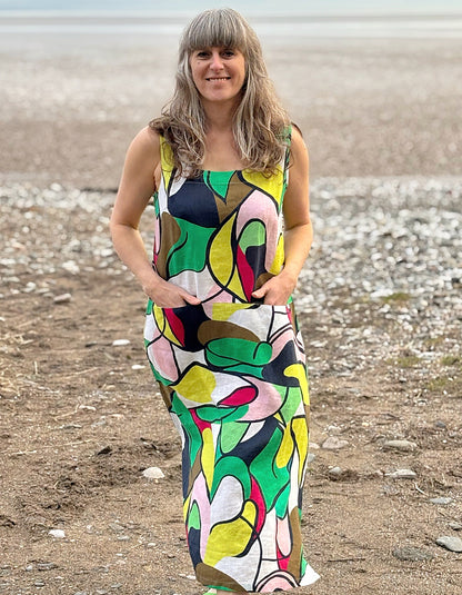 midi length linen dress with square neckline, sleeveless with pockets in abstract print in green pink yellow and navy