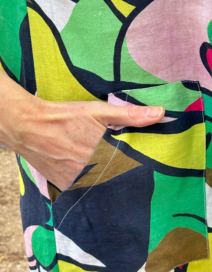 midi length linen shirt dress with pockets in abstract print in green pink yellow and navy