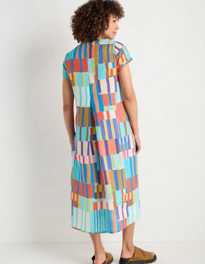 woman wearing bright coloured print linen midi dress