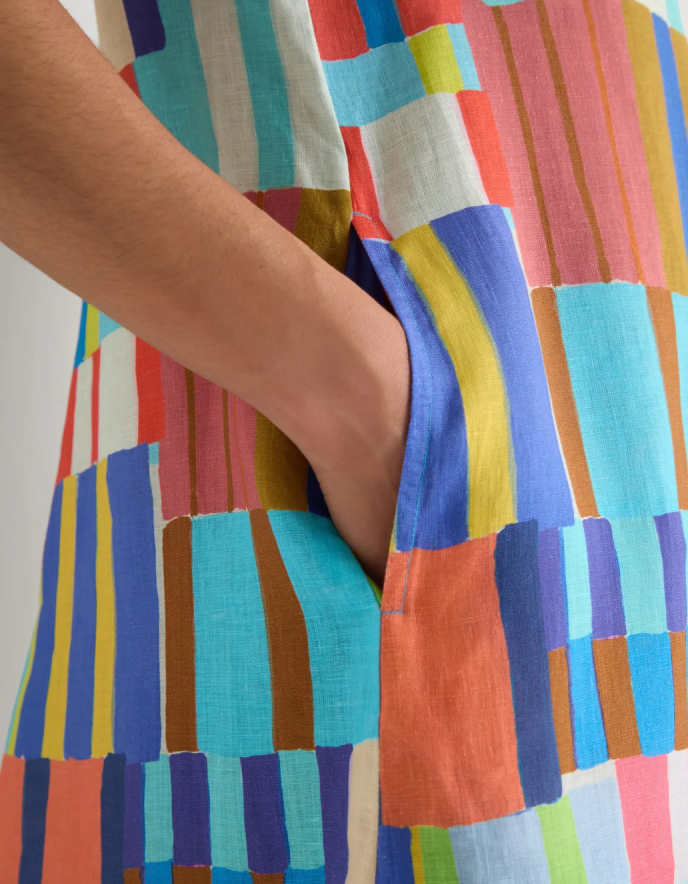 woman wearing bright coloured print linen midi dress