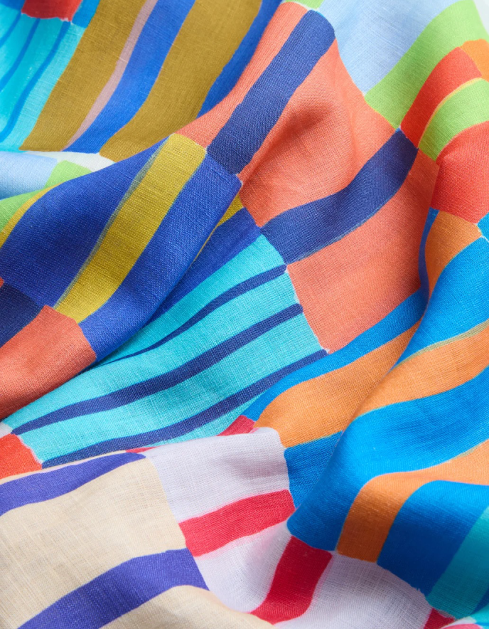 woman wearing bright coloured print linen midi dress