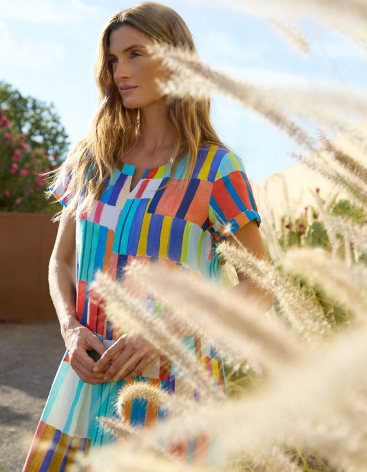 woman wearing bright coloured print linen midi dress