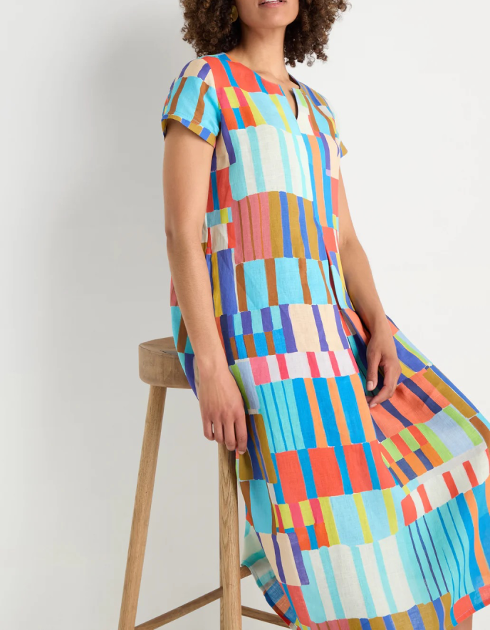 woman wearing bright coloured print linen midi dress
